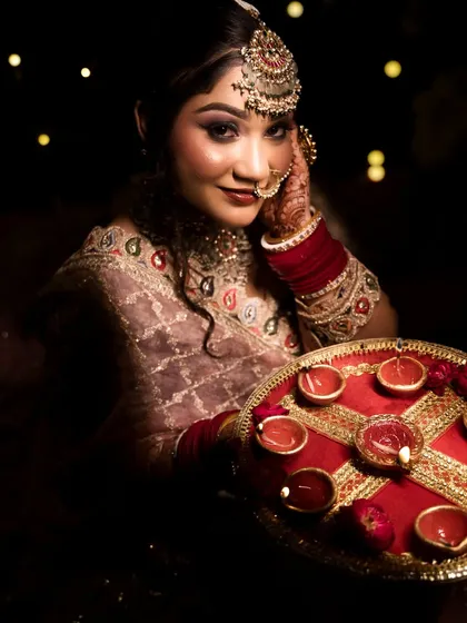The bride with her diya thali, a perfect shot for a festive-themed bridal portfolio.