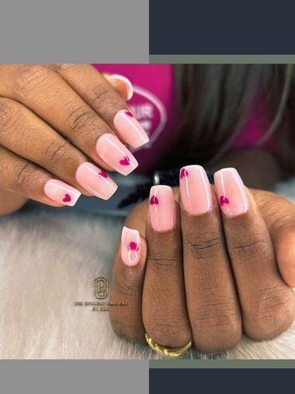 Sometimes, less is more. This minimalist design features a sheer pink base with tiny, hand-painted red hearts for a sweet and subtle touch of love.