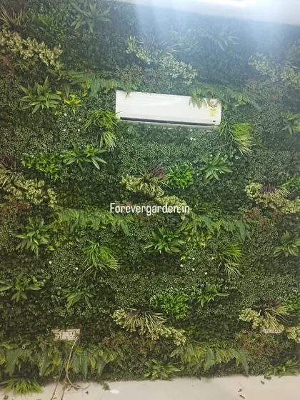 An indoor green wall designed to fit perfectly around an air conditioning unit, demonstrating how we customize installations for any wall.