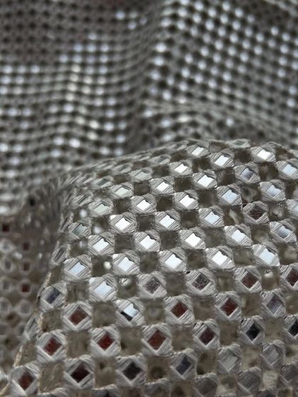 A beautiful beige version of our popular cutwork fabric. The neutral tone allows the shimmering details to truly shine.