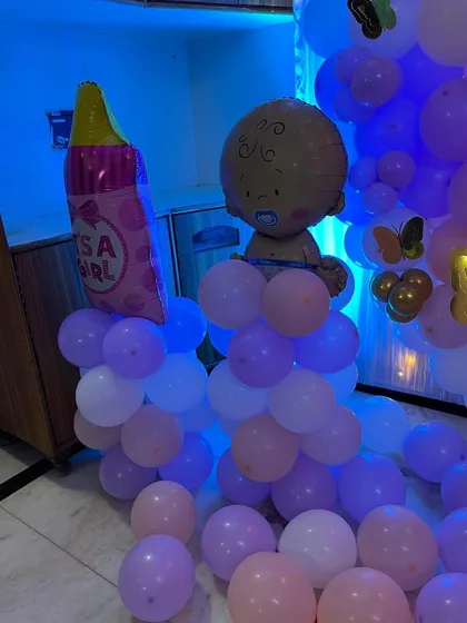 Themed foil balloons like this baby bottle and baby figure add a fun touch to the decor.