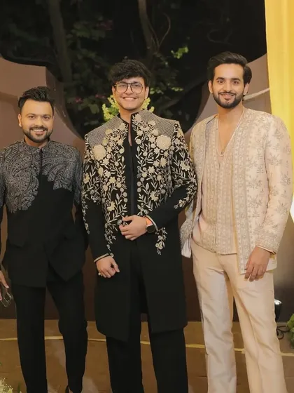 A group of clients wearing different styles of my custom indowestern jackets, showcasing the variety of designs available.