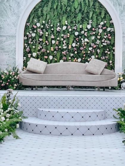 The centerpiece of this stage is a beautiful floral wall set within a grand arch. The design provides a perfect photo opportunity, with a comfortable lounge sofa for the celebrated couple.