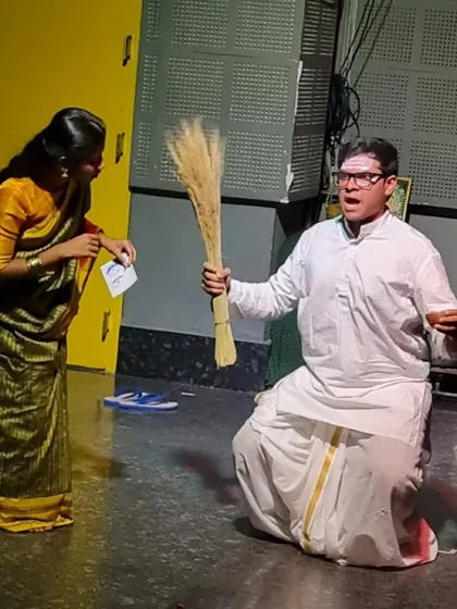A student actor in a comedic role from "The Good Doctor," holding a broom with dramatic flair.