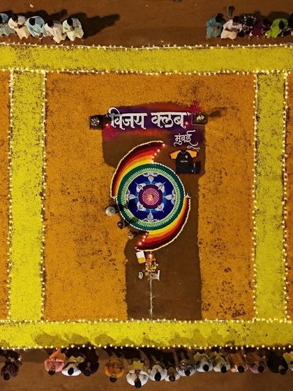 A stunning top-down view of the flower rangoli depicting our club's name.