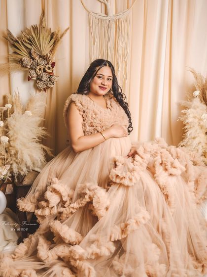A seated portrait in our Paige gown. The voluminous ruffles create a beautiful, cloud-like effect around the client.