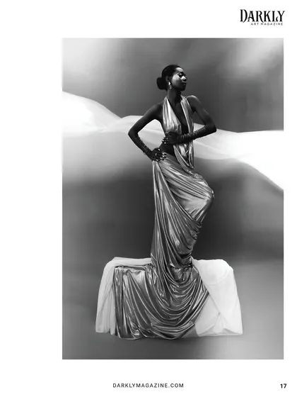 The beauty of this shot is in the contrast of light and shadow, with the sleek hair and makeup providing a focal point against the flowing white fabric.