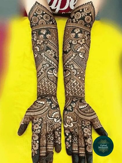 A very intricate and dense full-arm design, showcasing a variety of traditional patterns and techniques for a truly stunning bridal look.