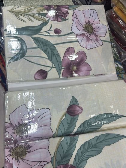 A beautiful large-scale floral print on a cream background. The purple and pink flowers with green leaves give this premium cotton bedsheet a soft, artistic look.