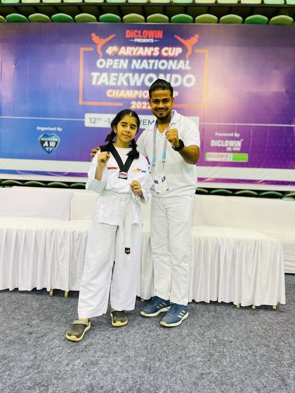 This student proudly displays her bronze medal from the 4th Aryan Cup Open National Taekwondo Championship. Her hard work paid off on a national stage.