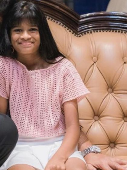 A sweet client wearing her light pink crochet top. The open stitchwork makes it lightweight and perfect for warmer weather, and the simple design is comfortable for play.