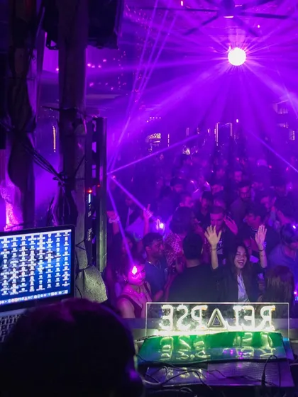 A view from my perspective, looking out at the packed club under purple lights.