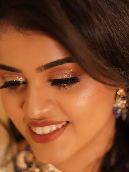 The glitter on Payal's eyelids catches the light beautifully in this close-up. This is the kind of detail that makes a reception look truly stand out.