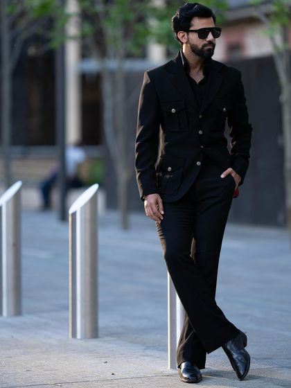 A relaxed pose in the black Viaggio Blazer, a versatile jacket for any travel wardrobe.