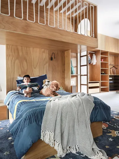 A child's room should be a world of its own. For this space, we designed a custom double-decker bed from exposed birch plywood, creating a playful yet timeless "treehouse" where imagination can take flight.