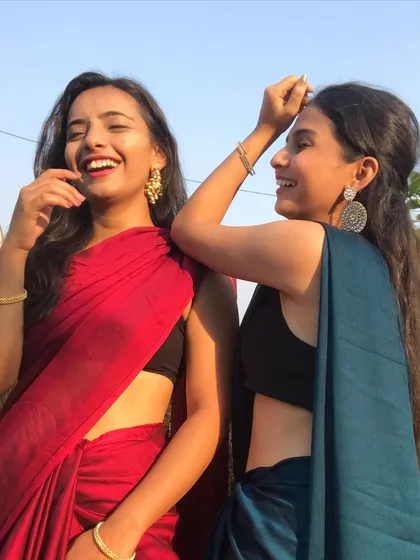 Sharing a laugh while dressed in sarees for a wedding event. Our approach is all about having fun, and we make sure the choreography process is as enjoyable as the final performance.