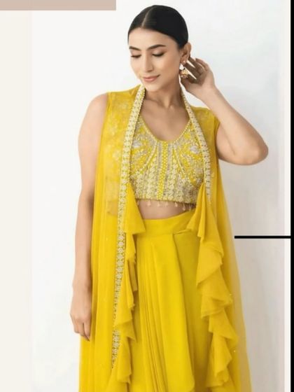 Another view of the modern yellow outfit, perfect for a fashion-forward guest or bride at a pre-wedding event.