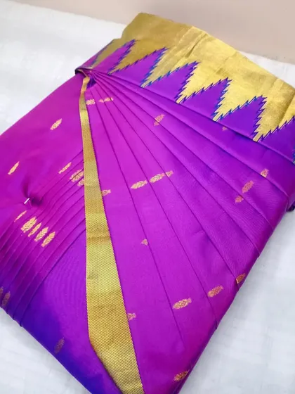 A unique purple saree with a temple border, pleated for a flawless drape.