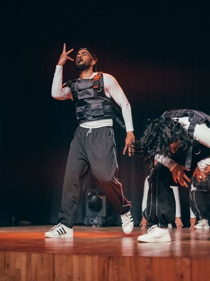 An instructor leads the hip-hop piece with authentic style and power, showcasing the foundations of the dance.