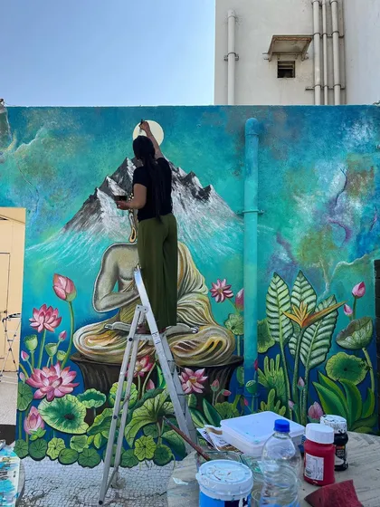 Here I am, working alone to finish this huge mural in Ahmedabad. It was a challenging but incredibly rewarding project.
