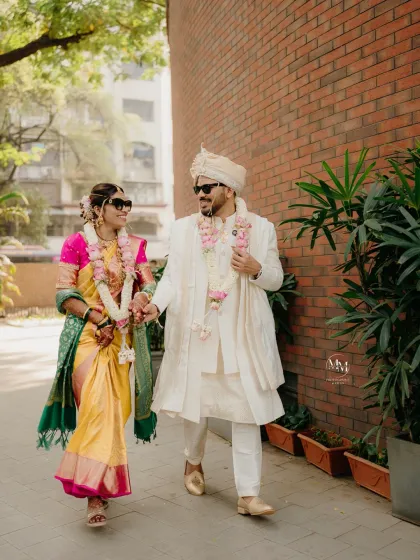 The 'cool' bride and groom, walking hand-in-hand after their wedding ceremony. This shot perfectly blends tradition with a modern, fun attitude.