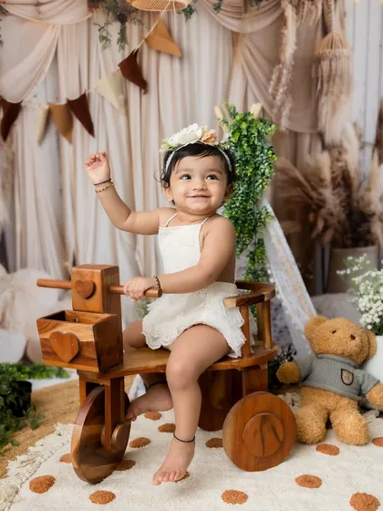 A beautiful portrait of the big sister enjoying the boho-themed studio setup.