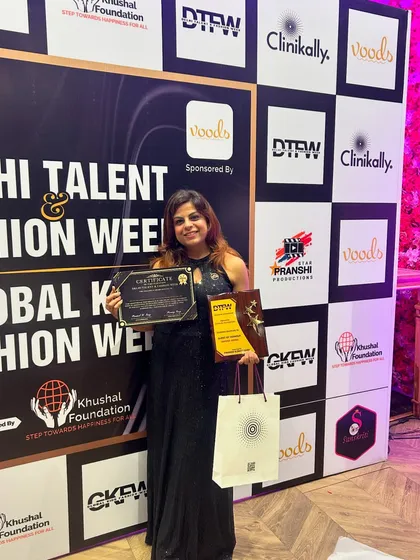 A jury member poses with her award, certificate, and a sponsored goodie bag. This shows how we integrate our sponsors' branding into every aspect of the event, from the stage to the gifts.