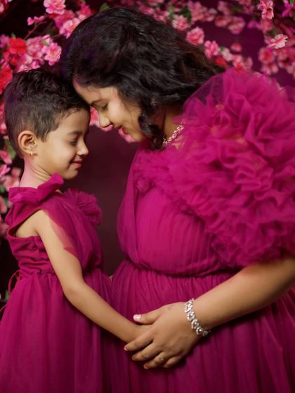 Creating precious memories before the new arrival. We offer matching mother-daughter gowns so your little one can be part of your maternity photoshoot. This is our magenta tulle gown set.