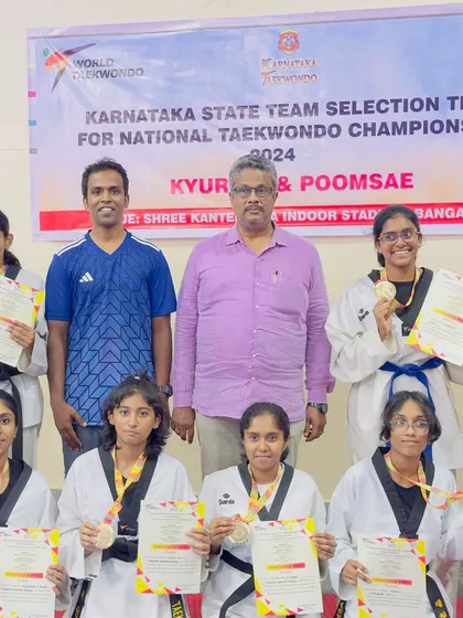 Our female champions posing with their well-deserved medals. We are dedicated to empowering girls and women through martial arts.