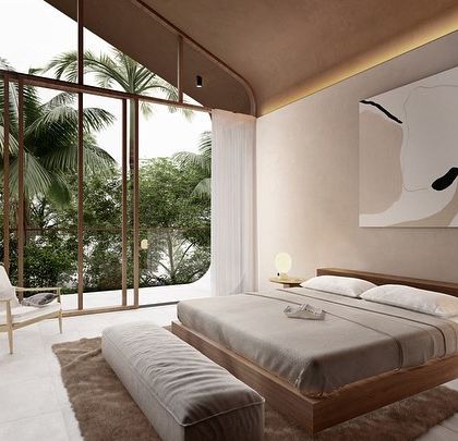 This bedroom in our Vagator Villas project features a soaring, curved ceiling and a large window framing the tropical view. The design uses minimal lines and earthy finishes to create a calm, uncluttered sanctuary.
