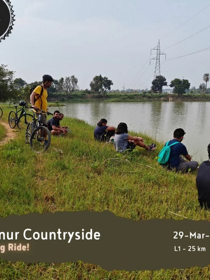 Our 'Hennur Countryside' evening ride is a great option for a quick escape. This image shows a group relaxing by the lake, a perfect end to a 25 km ride.