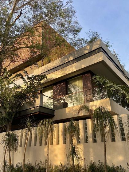The play of light and shadow, textures, and materials brings our residential designs to life. At this private home, the combination of a terracotta 'jaali', cantilevered balconies, and lush palm trees creates a perfect atmosphere of a tropical modern sanctuary.
