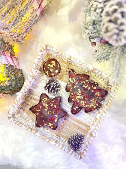 A beautiful flat lay of our Christmas plum cakes. This festive tray features our star-shaped, tree-shaped, and round plum cakes, perfect for a holiday dessert platter or as a thoughtful gift.
