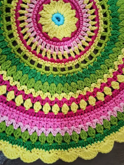 A close-up detail of the Viola mandala's colorful stitches.