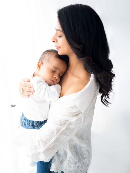 A peaceful moment of a mother holding her sleeping baby close.