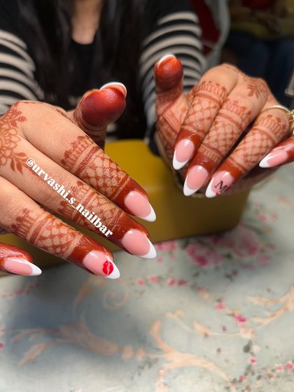 A playful twist on the classic French manicure for a bride. I added a tiny hand-painted kiss mark and an initial to make this set personal and unique.