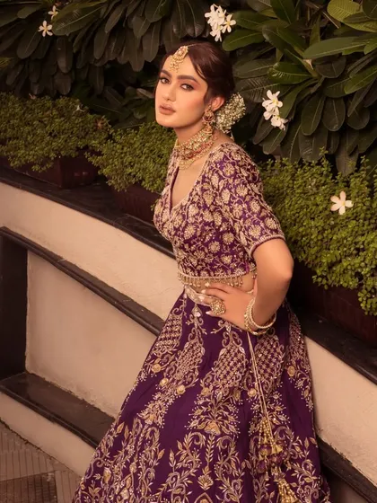 A beautiful portrait in the purple lehenga. The styling is elegant and timeless, perfect for a grand wedding reception.