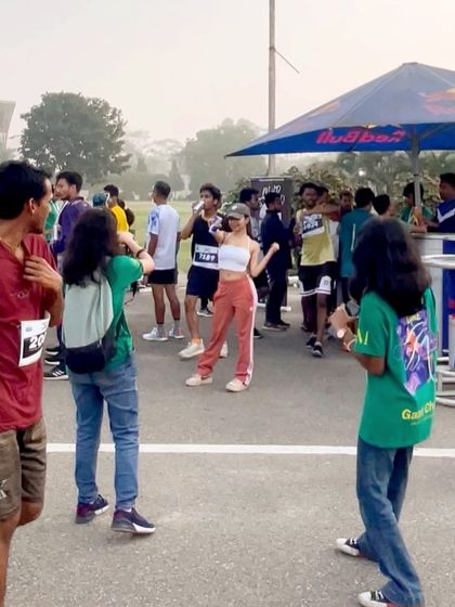 Interacting with participants at a Red Bull station during the Guwahati Half Marathon. My event services often include engaging with the audience directly to create a lively atmosphere.