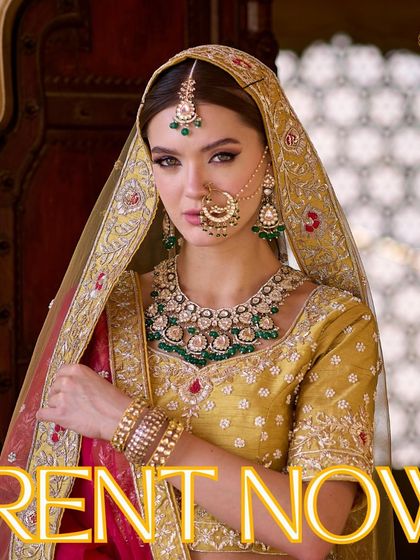 Elevate your bridal look by renting our regal jewellery. This model pairs a stunning emerald and Kundan set with a mustard yellow lehenga, creating a beautiful contrast.