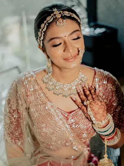 Capturing the soft magic of a sundowner phera. For this bride, I created an enchanting and dewy makeup look with soft pink tones and shimmering eyes that complemented her pastel lehenga and the romantic sunset lighting.