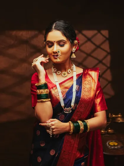A three-quarter shot showing the full grace of the Nauvari saree and the traditional jewellery.