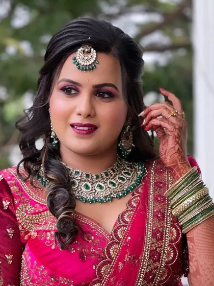 The bride looking confident and beautiful in her red reception outfit.