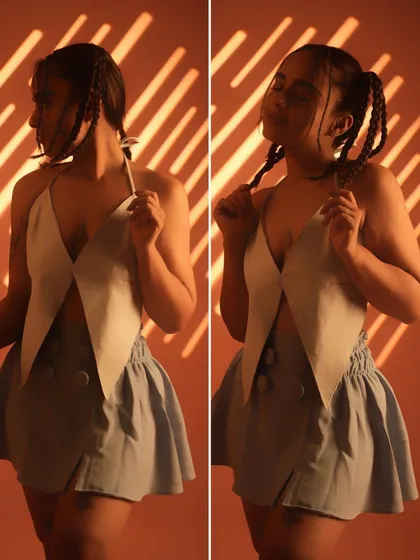 A playful, stylish look. This photo, with its unique top and braids, showcases my love for fashion and my experimental, fun-loving side.