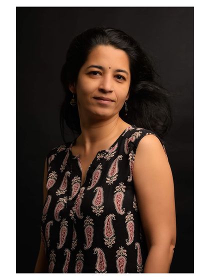 This portrait captures a soft, gentle expression, enhanced by the timeless quality of the black and white medium.