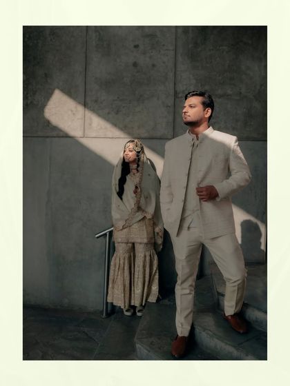 An artistic shot of the couple, with a dramatic slash of sunlight creating a high-contrast, modern, and stylish portrait.