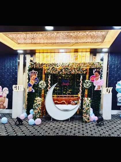 The same baby shower setup in a hall with a beautifully decorated ceiling, showing how my decorations complement the venue's features.