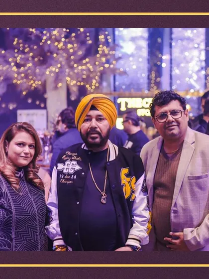 Cooking up smiles with every flavorful bite. Our founders, Sakshi and Lalit Tuli, pictured with singer Daler Mehndi at a glamorous event we catered.