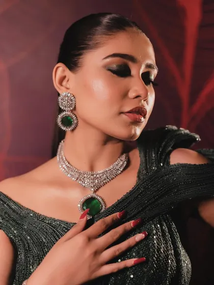 A close-up of the bottle green cocktail look. The deep, smokey eyeshadow is blended perfectly for a dramatic yet sophisticated finish.