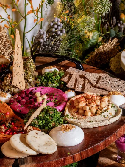 A feast for the eyes and the palate. Our vibrant Mezze platters are a celebration of Mediterranean flavors, featuring an array of colorful hummus, fresh dips, artisanal crackers, and accompaniments, perfect for social gatherings.