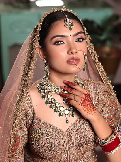 A captivating gaze. This close-up highlights the striking eyes, flawless skin, and the traditional nath, embodying the essence of a modern Indian bride.